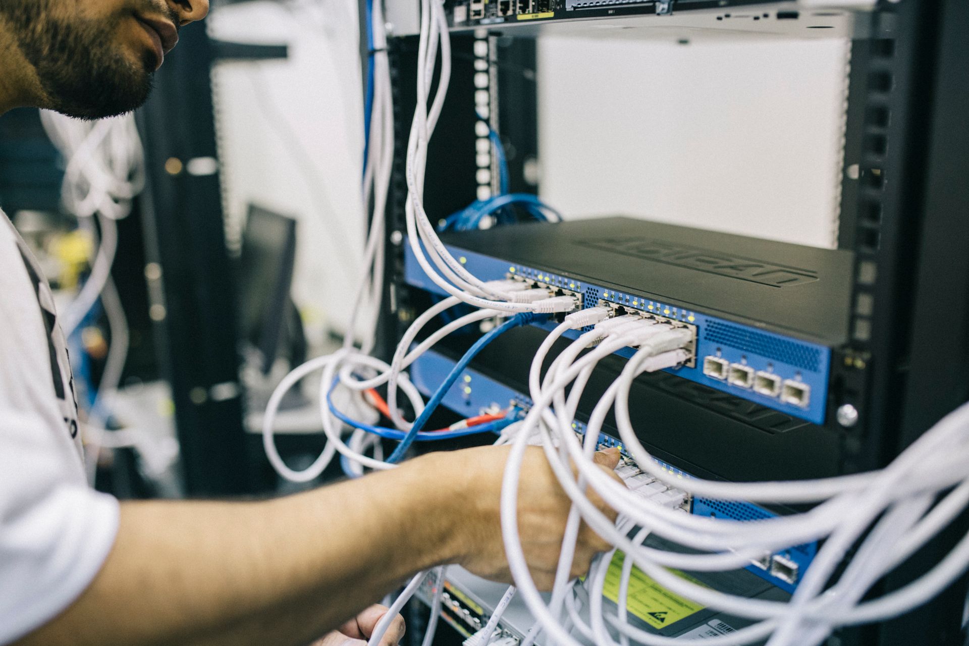 Network engineer configuring server rack